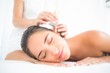 © WavebreakMediaMicro - Beautiful woman receiving ear candle treatment at spa center