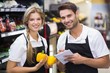 © WavebreakMediaMicro - Portrait of two colleagues holding vegetables and notepad
