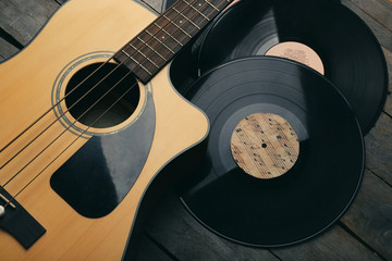 Poster - Guitar and vinyl records on wooden table close up