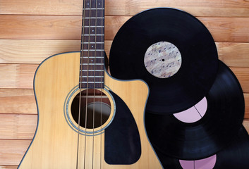 Poster - Guitar and vinyl records on wooden table close up