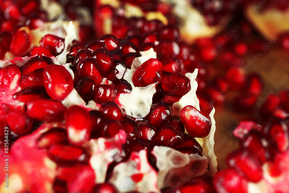 Pomegranate seeds on metal tray, closeup