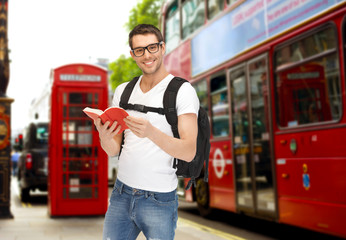 Sticker - happy young man with backpack and book travelling