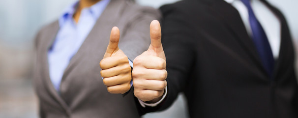 Poster - businessman and businesswoman showing thumbs up