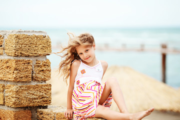 Portrait of a pretty little girl with waving in the wind long ha