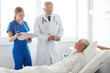 © Syda Productions - doctor and nurse visiting senior woman at hospital