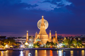 Wat Arun Temple in night with the moon at bangkok thailand.