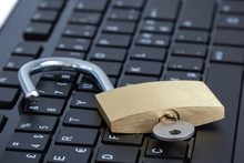 Close-up Of A Key In An Unlocked Padlock On A Computer Keyboard. Concept Photo Of Internet And Computer Security.
