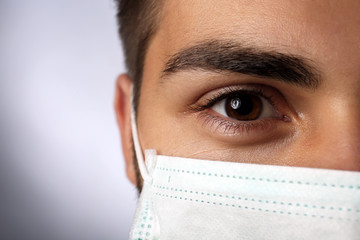 Poster - Young male doctor on gray background