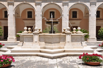 Wall Mural - Stone fontana against the building with arcades in the Monastery of Monte Cassino