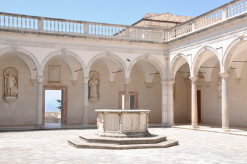 Courtyard Benedictine Monastery at Monte Cassino, a stone fountain and arcades