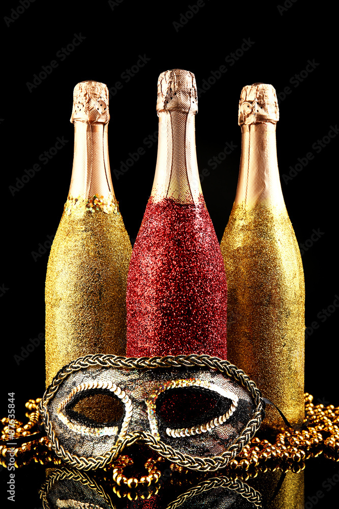 Decorative champagne bottles on dark background