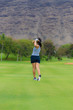 © Allen.G - Female golfer hits golf ball from fairway with an iron