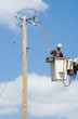 Utility Worker and Power Pole – A utility workers fixes a power line.