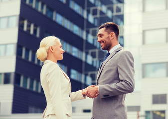 Wall Mural - smiling businessmen standing over office building