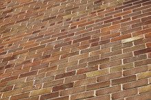 Close Up Of A High, Red Brick House Wall At Angle In Perspective