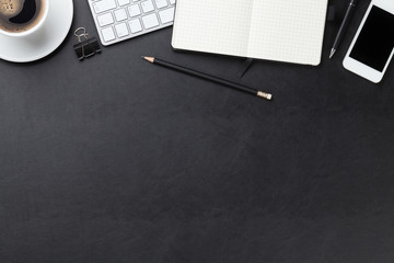 Office leather desk with computer, supplies and coffee