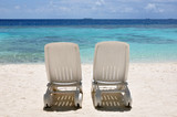 Fototapeta  - Two beach chairs on the beach.