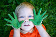 © natalinka29 - Boy with hands painted in green paints ready to make hand prints