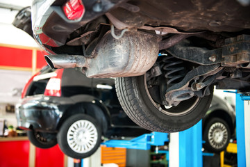 Wall Mural - Vehicle in a repair workshop on a lift or hoist