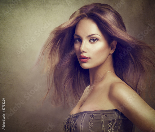 Fototapeta na wymiar Fashion model girl portrait with long blowing hair