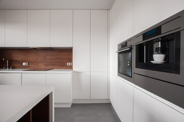 White furniture in wooden kitchen