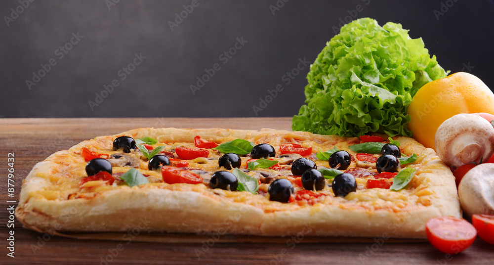 Delicious homemade pizza on table on black background