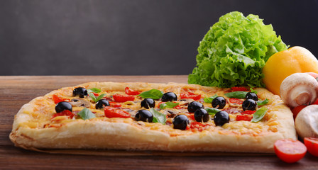 Delicious homemade pizza on table on black background