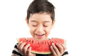 Little boy eating watermelin on white background