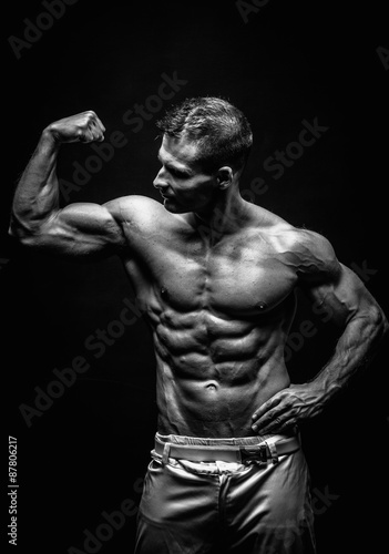 Naklejka dekoracyjna very muscular handsome athletic man on black background