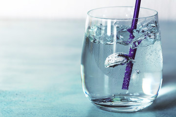 Wall Mural - Glass of water with bubbles on table close up