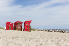 Beach Chairs By The Sea / Baltic Sea Beach With Red Beach Chairs And Blue Sky 