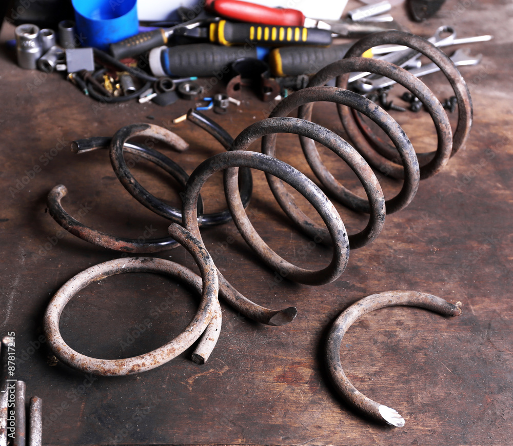 Large metal spring on workplace in garage
