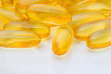 Fish oil capsules on white background