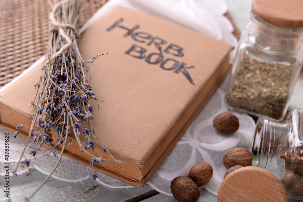 Dry lavender with nutmeg and book on table close up