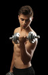 © Africa Studio - Muscle young man holding dumbbell on dark background