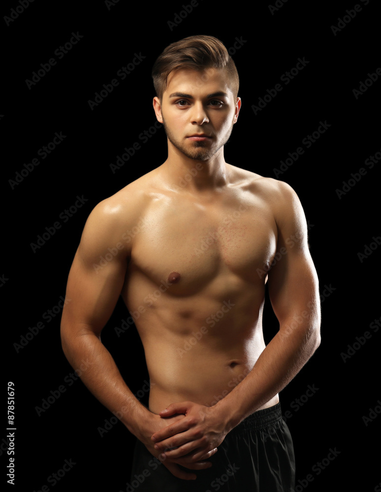 Muscle young man on dark background