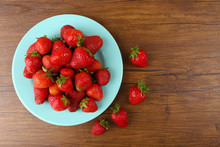 Ripe Strawberries In Plate On Wooden Background