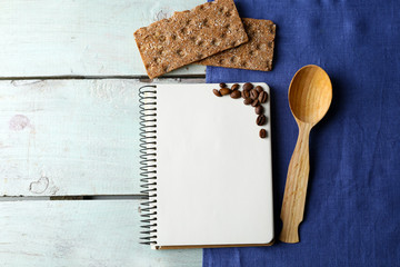 Open recipe book on wooden background