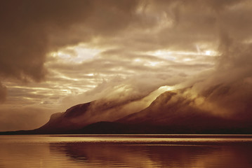 Wall Mural - Landscape. Mountains and lake in mist in morning with yellow col