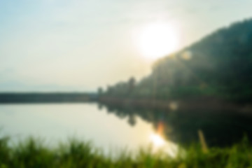 blurry landscape with lake at sunrise