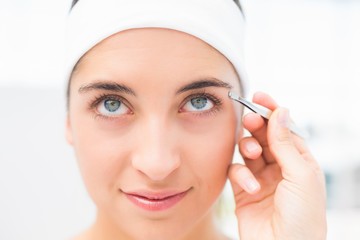 Wall Mural - Hand applying eyeshadow to beautiful woman