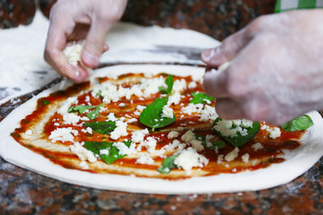 Sticker - Chef preparing pizza on marble table, closeup