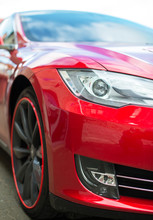 Close-up View Of Red Sports Car Headlight.