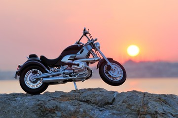 Wall Mural - Motorcycle on the rocks in sunset and golden hours