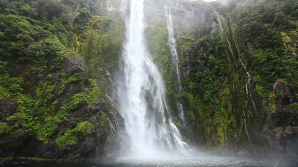 Sticker - Close approach to waterfall by boat, Milford Sound Fjord. South Island, New Zealand.