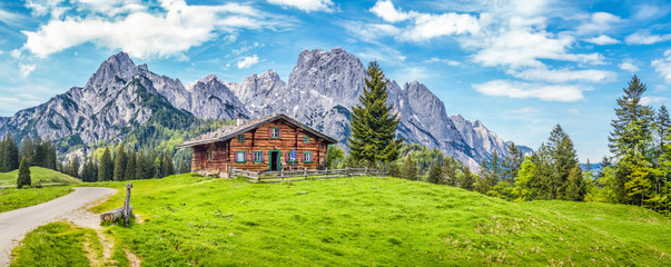 Wall Mural - idyllic landscape in the alps with mountain chalet and green meadows