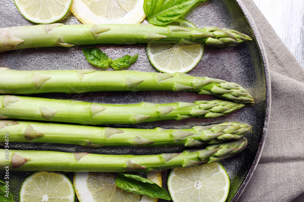 Fresh asparagus on pan, close-up