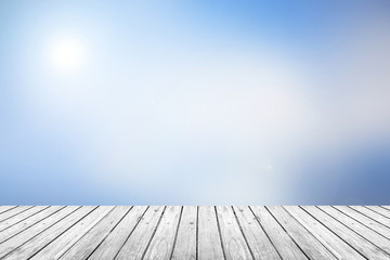 Wall Mural - wooden floor with blue sky blurred background