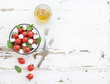 © sonyakamoz - Caprese salad: cherry-tomatoes and mozzarella in metal bowl with