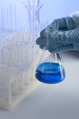 Wall Mural - test tube in scientist hand in laboratory